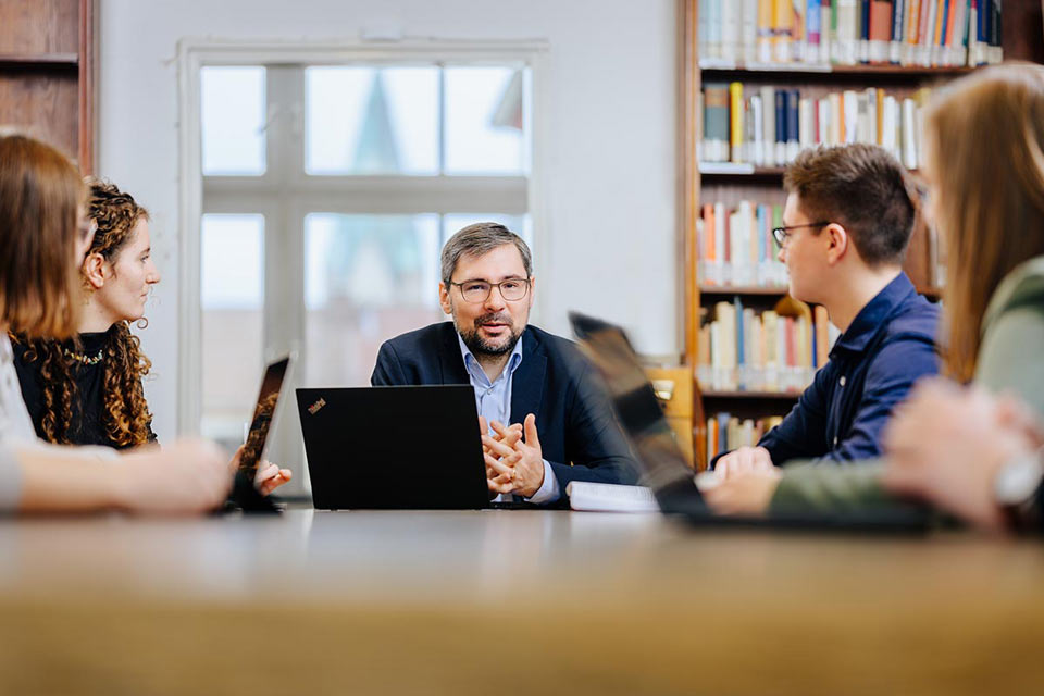 Professor mit Studierenden im Unterricht