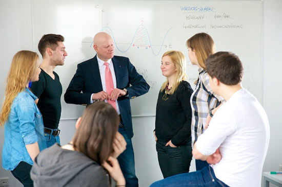 Studierende der HMKW beim Diskutieren mit ihrem Dozenten