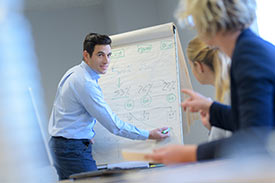 Ein Marketing Manager beschreibt seine Ideen an einem Flipchart