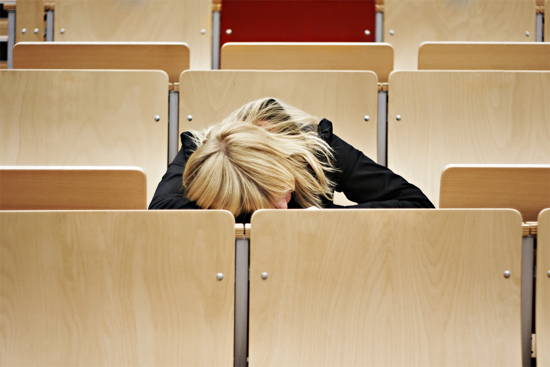 Studentin im Hörsaal, offenbar schlafend.